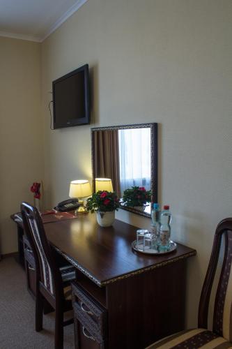 a room with a desk with a mirror on the wall at Галицька Корона in Lviv