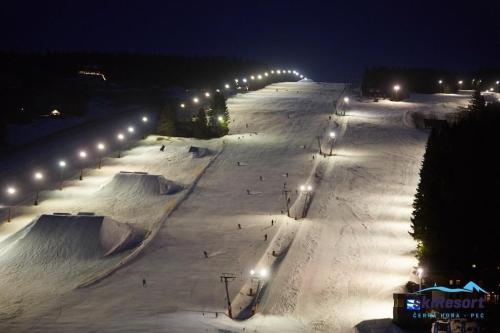 a skate park at night with skate ramps and lights at Hotel Oddech in Pec pod Sněžkou