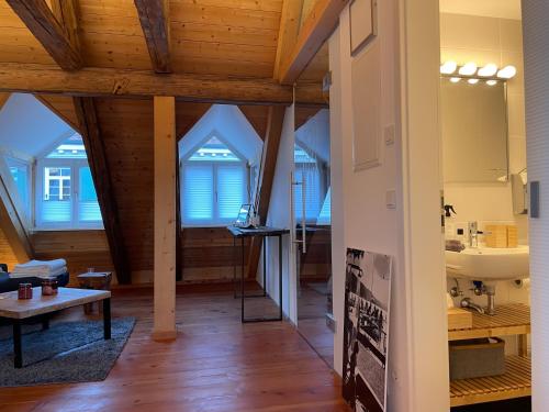a living room with wooden ceilings and wooden floors at INVERA HOME in Murnau am Staffelsee