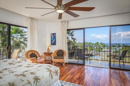 a bedroom with a bed and a view of the ocean at Kahaluu Bay Village 201 by Casago Kona - Snorkeling, Surfing and Spaciousness in Kailua-Kona