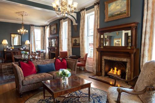 a living room with a couch and a fireplace at Kehoe House, Historic Inns of Savannah Collection in Savannah