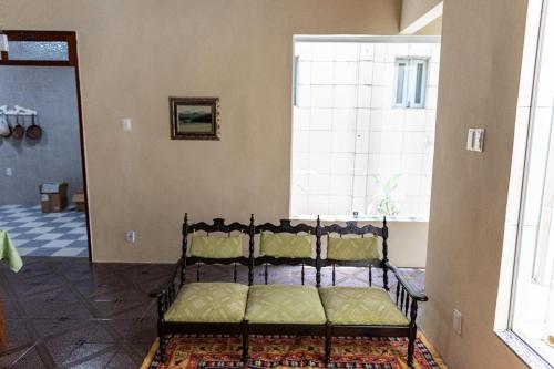 a bed sitting in a room with a window at Vila Barroca Estalagem in São Cristóvão