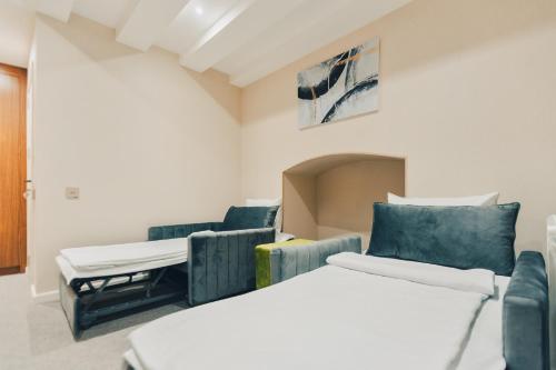 a room with two beds and a couch at Eleven Hotel Baku in Baku