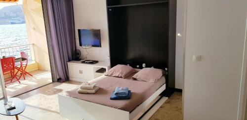 Un dormitorio con una cama con dos toallas encima. en Sudio bord de mer Ajaccio, en Ajaccio