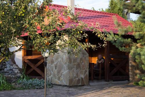 a building with a red roof and a tree at Галицька Корона in Lviv