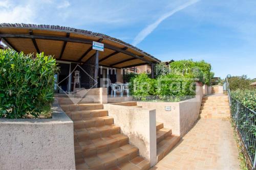 a set of stairs leading up to a building at 15B - Grazioso appartamento riservato a Porto Mannu in Palau