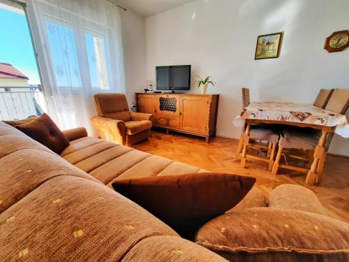 a living room with a couch and a table at Apartman Marina in Selce