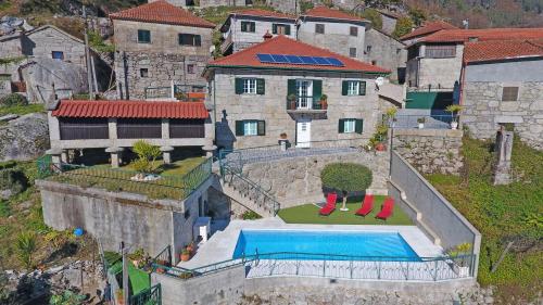 an aerial view of a house with a swimming pool at Eira Costa House by Gerês Casas in Geres