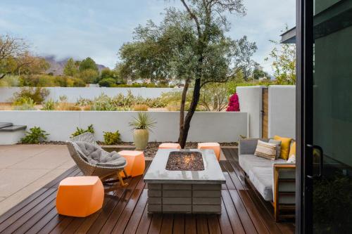 a patio with a couch and a tree on a deck at Andaz Scottsdale Resort & Bungalows in Scottsdale