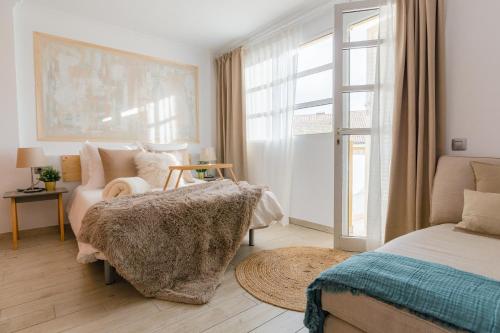 Postel nebo postele na pokoji v ubytování Arcasa by Villas Rinamar