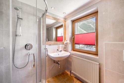 a bathroom with a sink and a shower at Pension Granbichler in Längenfeld