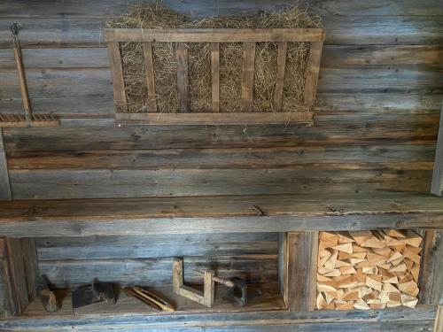 a wooden cabin with a bench and logs at Haus Schnöller in Bach