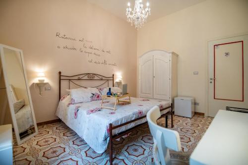 a bedroom with a bed with a table on it at Terre Dipinte in Salerno