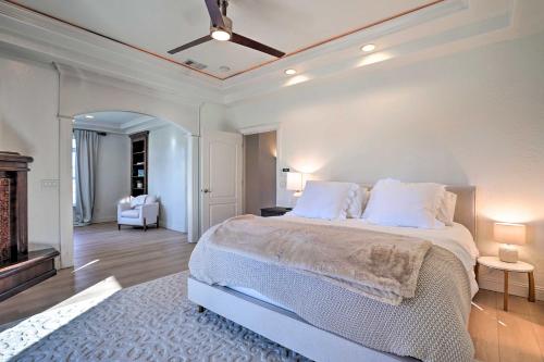 a white bedroom with a bed and a fireplace at Luxe Getaway with Riverfront Views in Grants Pass! in Grants Pass