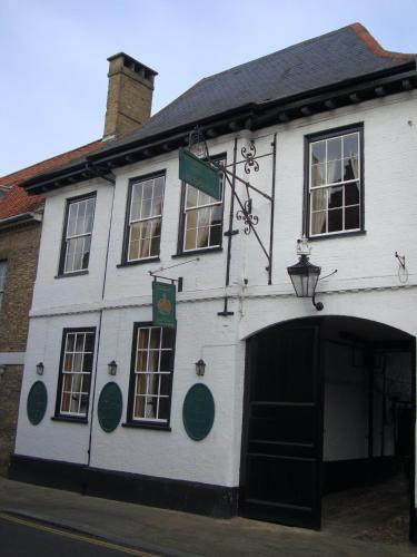 a white building with a large doorway in front of it at Crown Hotel in Downham Market