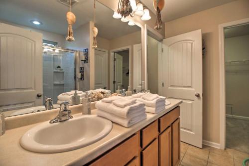 a bathroom with a sink and a large mirror at Screened Patio Rincon Home, 18 Mi to Savannah! in Rincon