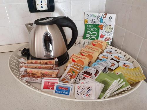 a plate with food and a tea kettle on a counter at Lietta 4 Apartment in Vittorio Veneto