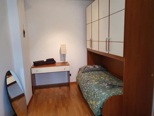 a small bedroom with a bed and a desk at Lietta 4 Apartment in Vittorio Veneto