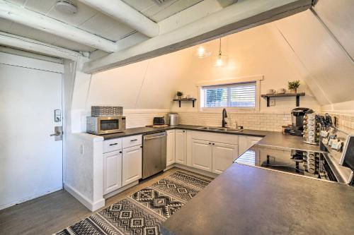 a large kitchen with white cabinets and a sink at Puget Sound Cabin with Hot Tub and Water Views! in Bremerton