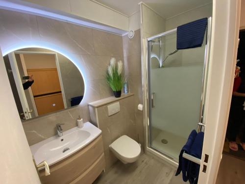 a bathroom with a sink and a toilet and a shower at Studio front de mer 'Le Soleillan' in La Grande Motte