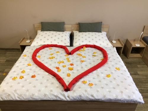 a heart shaped cake on top of a bed at Penzion Relax Litovel in Litovel