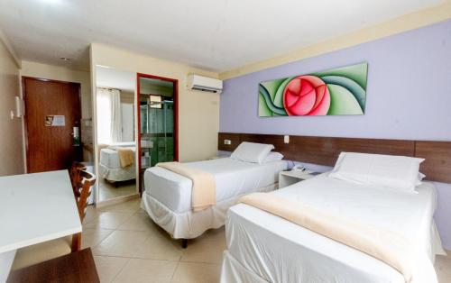 Katil atau katil-katil dalam bilik di Serra Golfe Apart Hotel