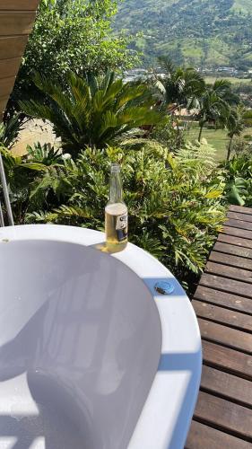 a bottle of beer sitting on top of a bath tub at Finca Hotel Tierra Verde in Girardota