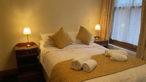 a bedroom with a bed with towels on it at Crown Hotel in Downham Market