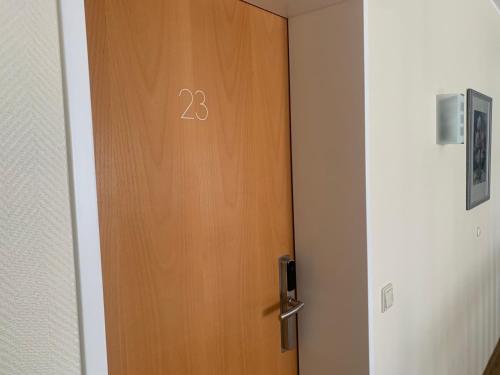 a wooden door with the number on it at Hotel Flora in Herzlake