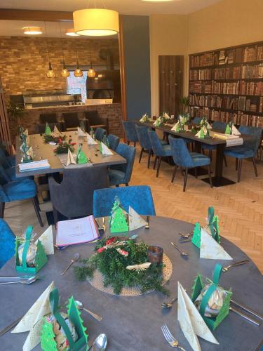 a group of tables in a library with christmas decorations on them at MediTerra in Papenburg