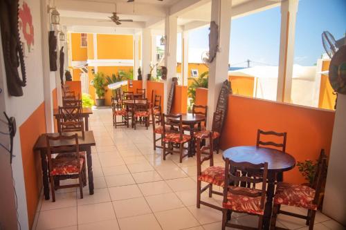 a row of tables and chairs in a restaurant at St. James Guesthouse in Roseau