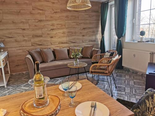 a living room with a couch and a table at Apartament Kołobrzeg Starówka Welcome Home in Kołobrzeg