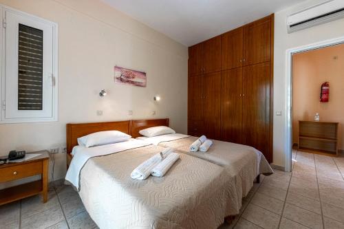 a bedroom with two beds with towels on them at Anesis Residence in Dhrepanon