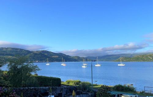 a group of boats on a large body of water at Kames View Apartment in Tighnabruaich