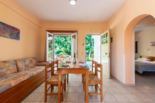 a living room with a table and a couch at Anesis Residence in Dhrepanon