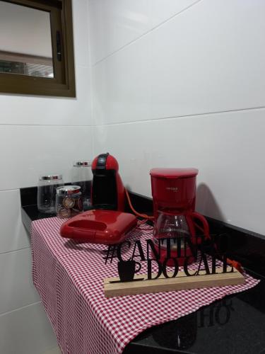 a table with a red blender on top of it at Apê da Fla in Arraial do Cabo