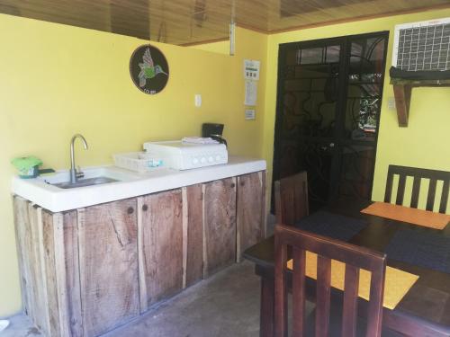 a kitchen with a counter and a sink and a table at Mundo Goub'art in Cabuya