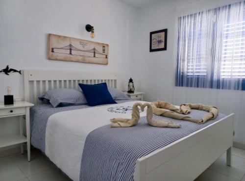 a bedroom with two beds with a stuffed animal on the bed at Sunrise Casita del Mar in Arrieta
