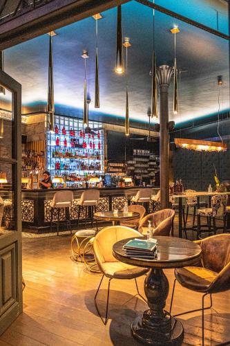 a restaurant with a table and chairs and a bar at Anesis Residence in Dhrepanon