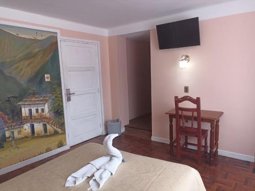 RIXAA Hotels في لاباز: غرفة فيها حيوان ابيض ملقي على السرير