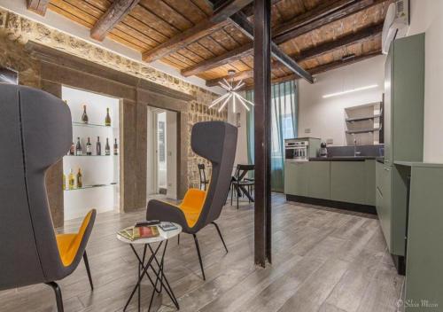 een keuken met 2 stoelen en een tafel in een kamer bij SDL luxury home Al Pavone in Viterbo