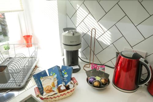 a counter top with a coffee maker and some treats at Albert Rd in Ramsgate