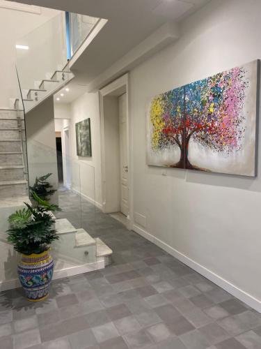 a large painting hanging on a wall in a hallway at DOMUS IOLE appartamento nel centro storico in Catania