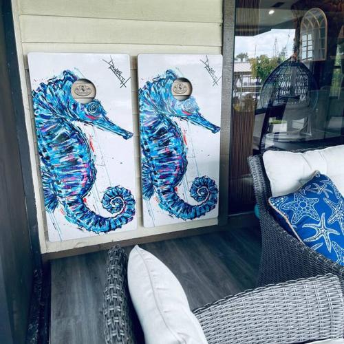 two paintings of a seahorse on display in a store at Paradise!! GolfCartRental/Paddleboat/Kayak/Fish/Swim in Hernando Beach