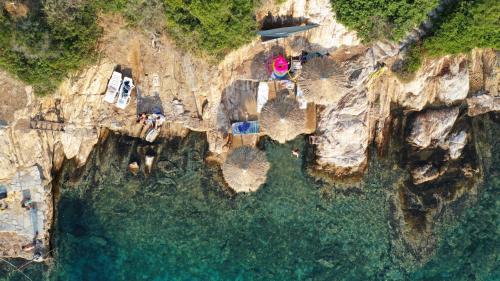 an aerial view of a cliff with the ocean at Ammou Area in Ammouliani
