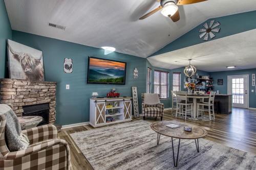 a living room with a couch a table and a fireplace at The Mason Jar, Hot Tub, WIFI, 560 FREE tickets each paid day in Pigeon Forge