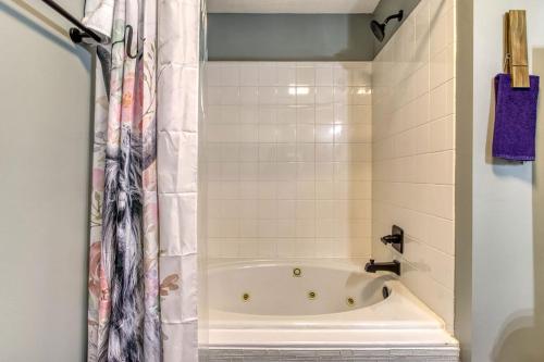 a bathroom with a tub and a shower curtain at The Mason Jar, Hot Tub, WIFI, 560 FREE tickets each paid day in Pigeon Forge