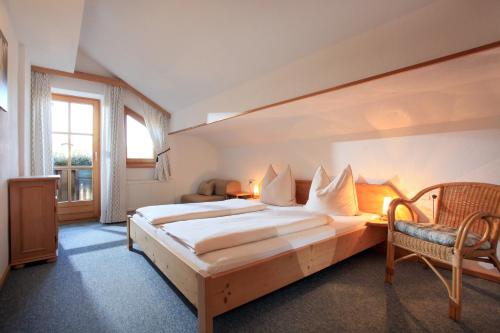 a bedroom with a large bed and a window at Appartement Paratscher in Westendorf