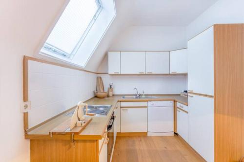 a kitchen with a sink and a skylight at Gästesuiten beim Schloss in Eisenstadt