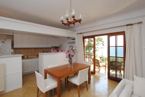 a kitchen and dining room with a table and chairs at Stavento Apartments in Argostoli